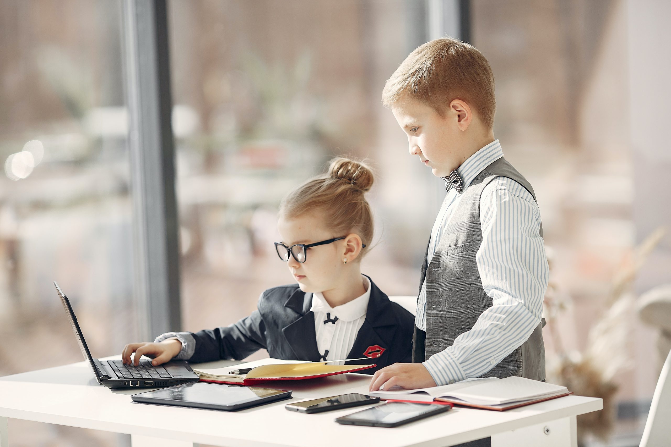 https://www.pexels.com/photo/cute-business-kids-working-on-project-together-surfing-laptop-in-light-workplace-3874121/